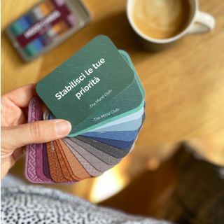 Carte per il lavoro colorate a ventaglio con caffè su scrivania